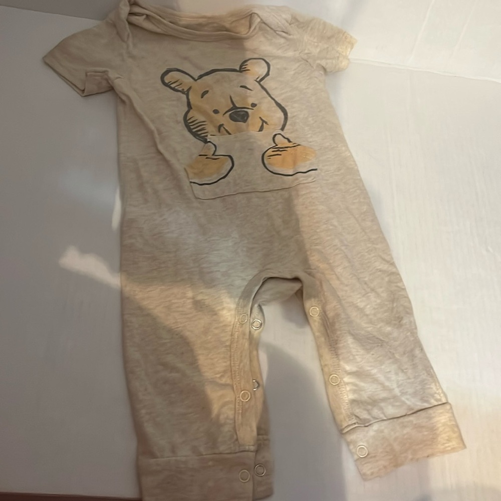 Disney Baby size 6/9 months oatmeal colored long leg onesie. Gently worn